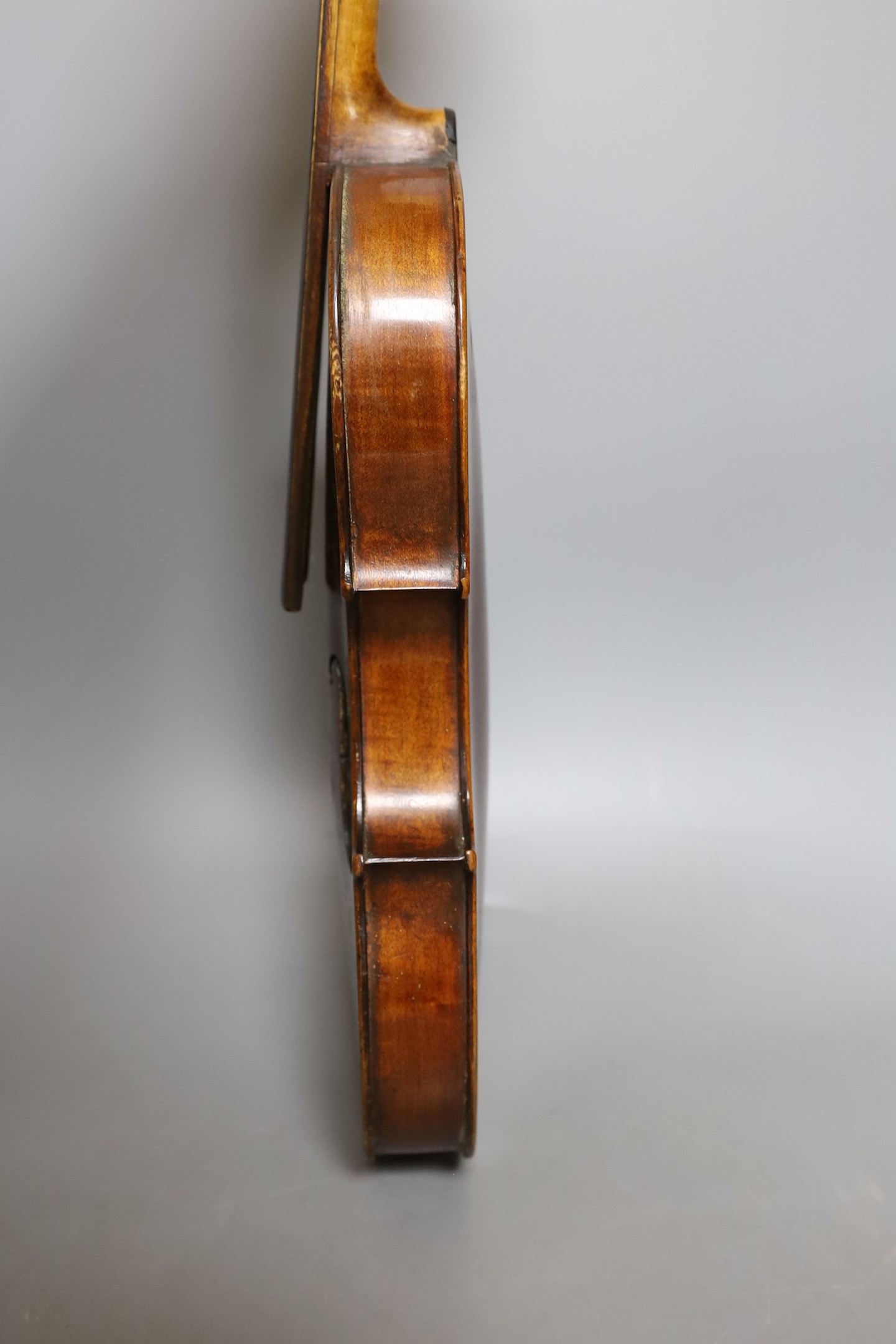 A European violin, circa 19th century, 59 cms long.